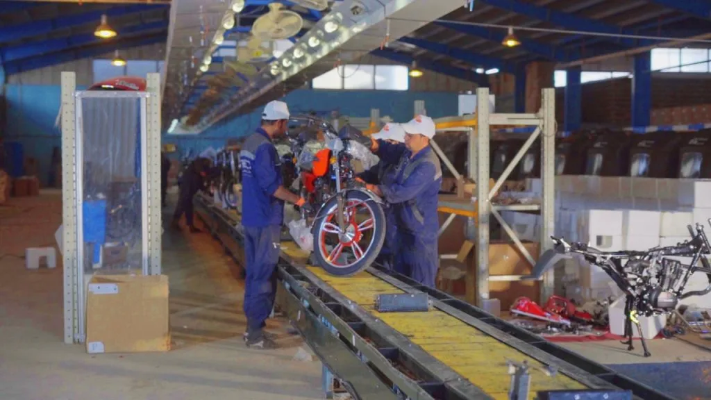Pamir employees working along the motorcycle assembly line in Herat